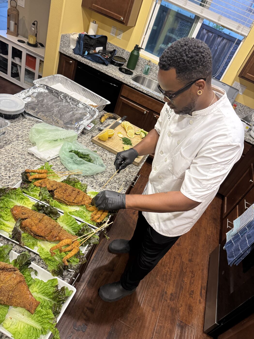 Chef King plating cornmeal fried fish in a client's home