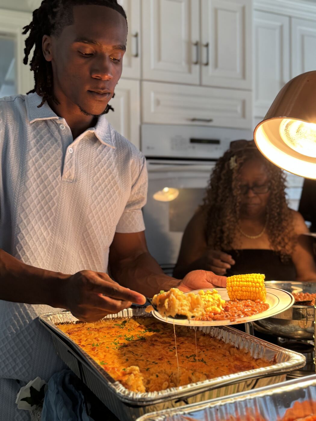 Soul food plate with mac and cheese, corn and a baked dish